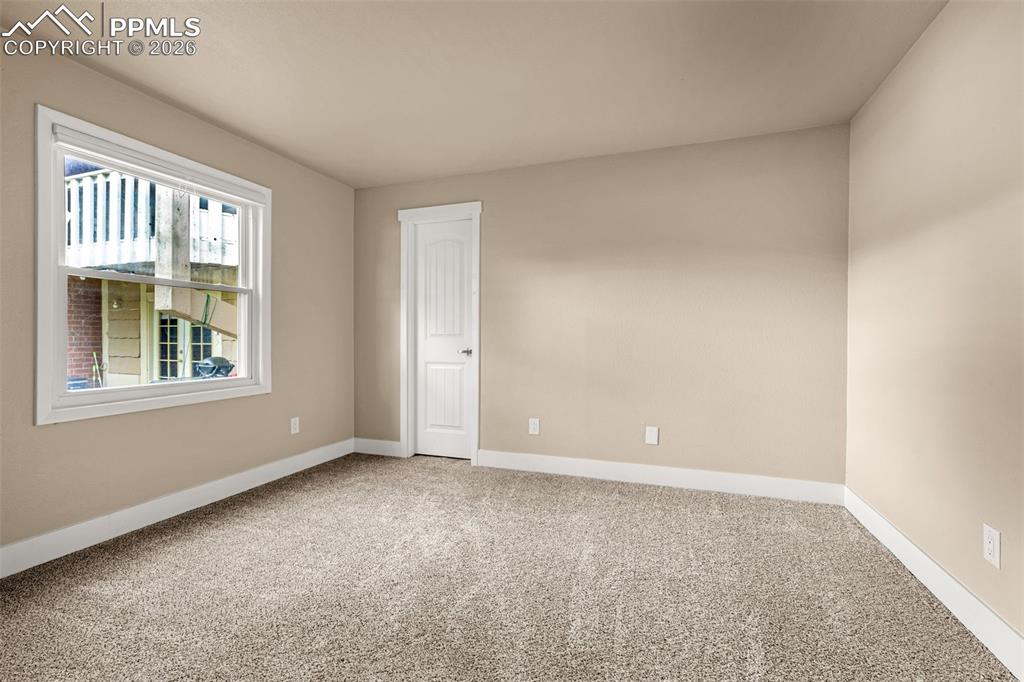 1679 Deer Creek Road Monument, CO 80132 - Photo 8 of 21 Unfurnished room featuring light carpet and baseboards