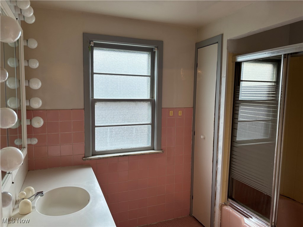 4308 Silsby Road University Heights, OH 44118 - Photo 12 of 28 Bathroom featuring tile patterned floors, vanity, bath / shower combo with glass door, and tile walls