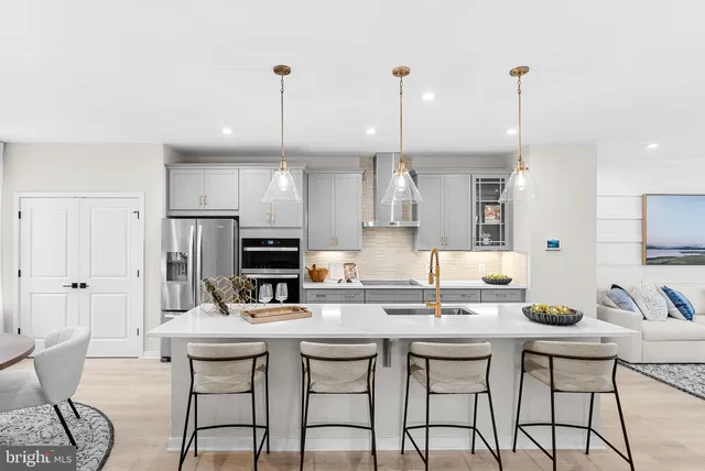 a kitchen with a sink a stove and chairs