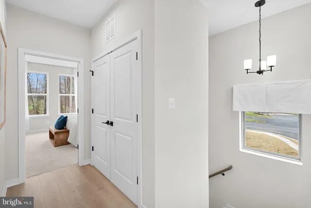 a bed room with a bed and a large window