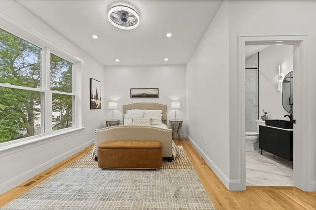 a bedroom with a bed and a large window