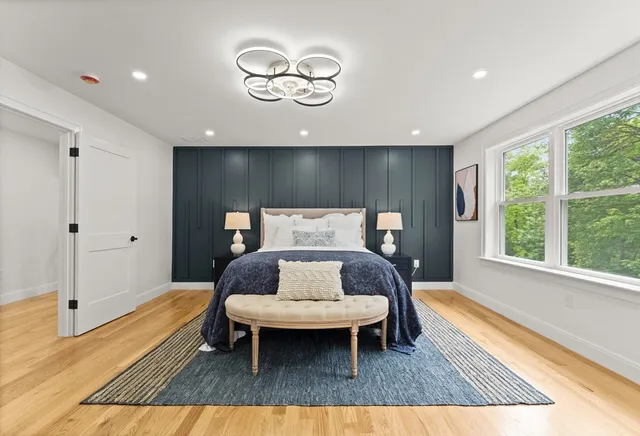 a living room with a rug and a wooden floor