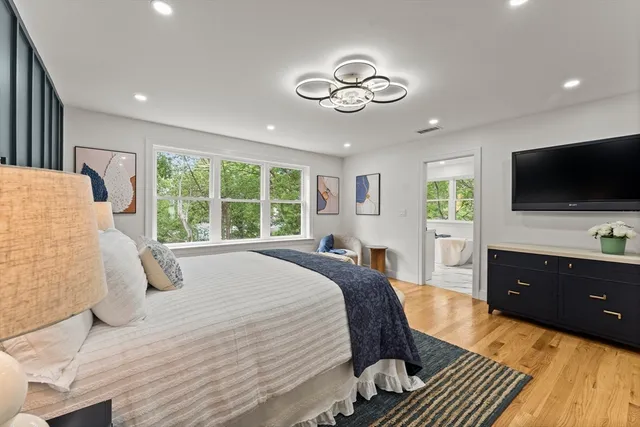 a bedroom with a bed and a flat screen tv