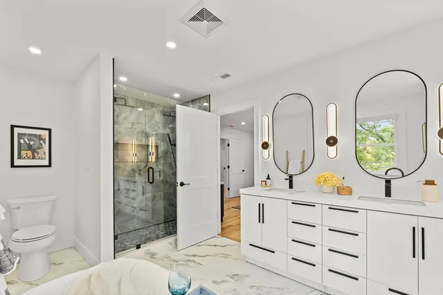 a bathroom with a toilet sink and mirror
