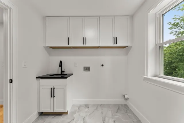 a view of cabinets with sink and dishwasher