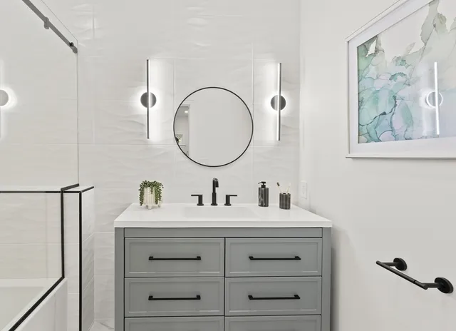 a bathroom with a double vanity sink and a mirror