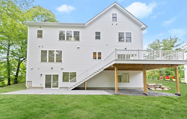 a front view of a house with a yard and potted plants