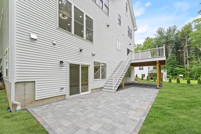 a view of a house with a yard and sitting area