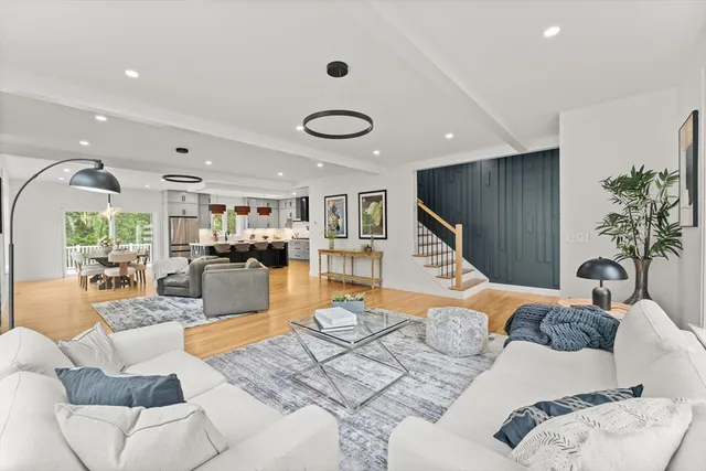 a living room with furniture gym equipment and a large window