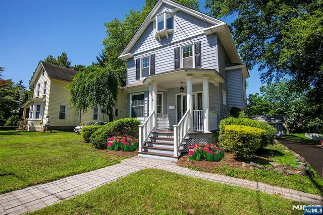 a front view of a house with a yard and porch
