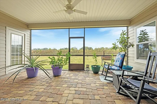 a living room with a floor to ceiling window and pool table