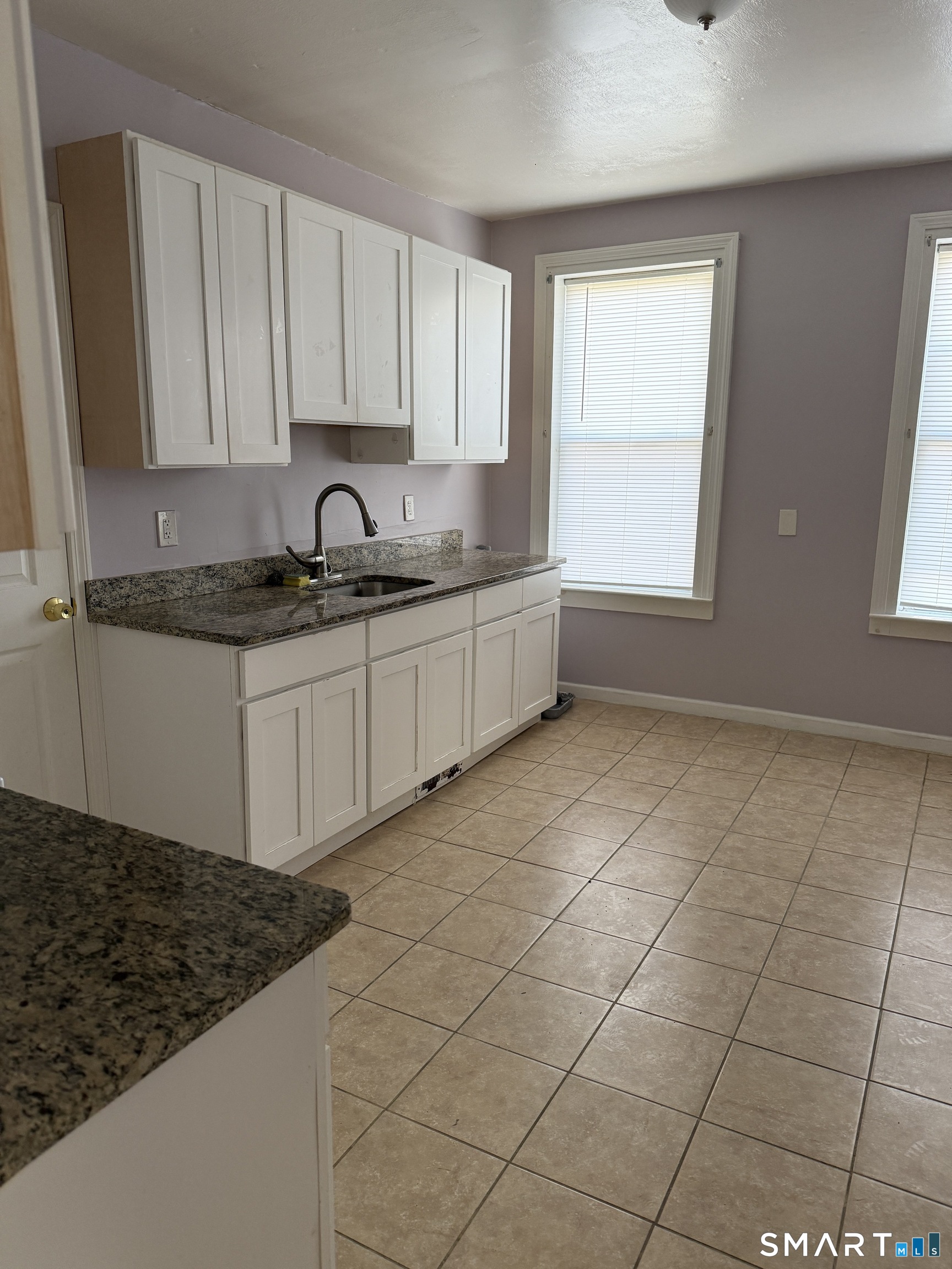 152 Scott Street Naugatuck, CT 06770 - Photo 2 of 7 a kitchen with stainless steel appliances granite countertop a sink stove and cabinets
