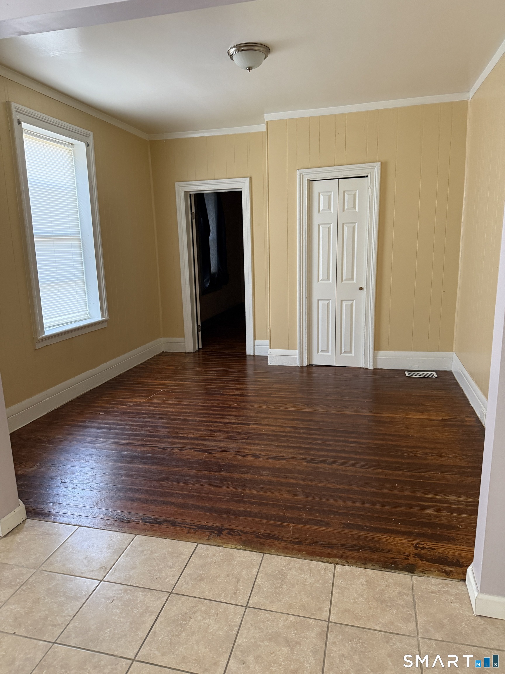152 Scott Street Naugatuck, CT 06770 - Photo 4 of 7 a view of an empty room with wooden floor and a window