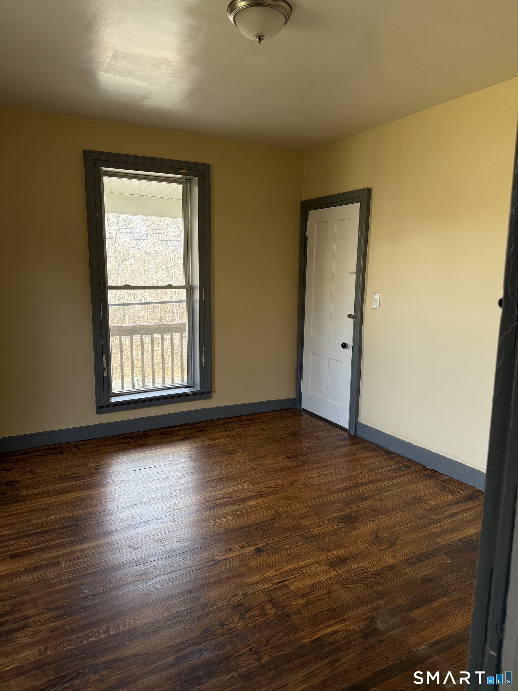 152 Scott Street Naugatuck, CT 06770 - Photo 5 of 7 a view of an empty room with wooden floor and a window