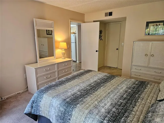 a bedroom with a bed and a television