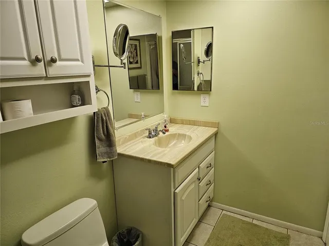 a bedroom with two beds lamp and a large window