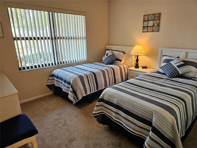 a bedroom with a bed and lamps