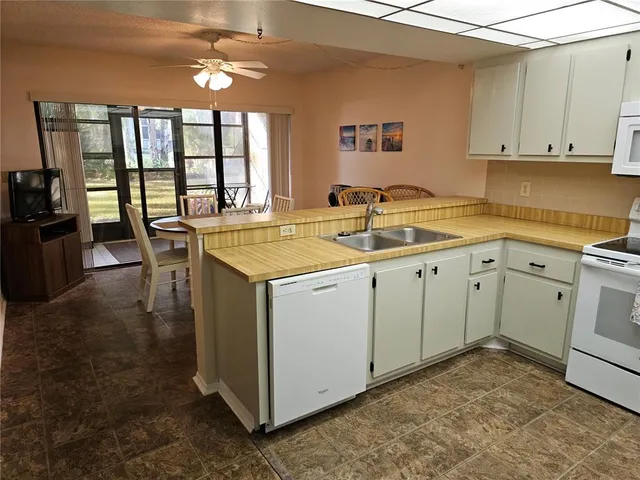 a kitchen with stainless steel appliances a refrigerator sink and cabinets