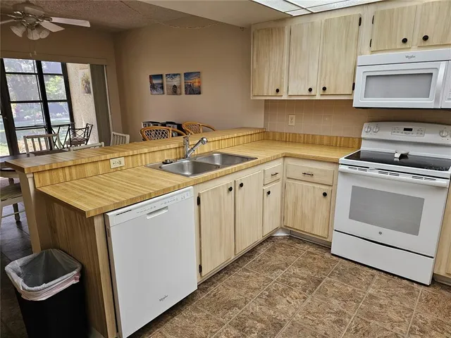 a kitchen with stainless steel appliances a refrigerator a sink a stove a microwave and cabinets