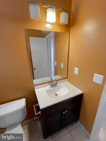 a bathroom with a sink mirror vanity and toilet