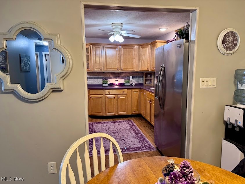 240 Spring Creek Road Northfield, OH 44067 - Photo 6 of 39 Kitchen with stainless steel refrigerator with ice dispenser, decorative backsplash, ceiling fan, a textured ceiling, and wood-type flooring