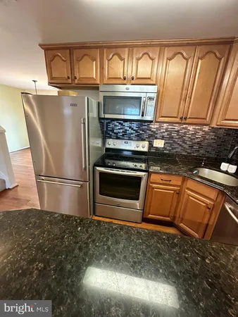 a kitchen with a stove and a refrigerator
