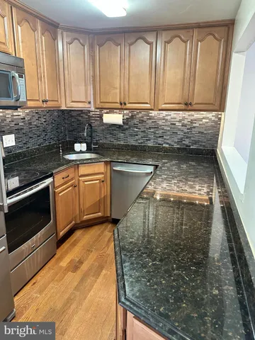 a kitchen with a refrigerator and a sink