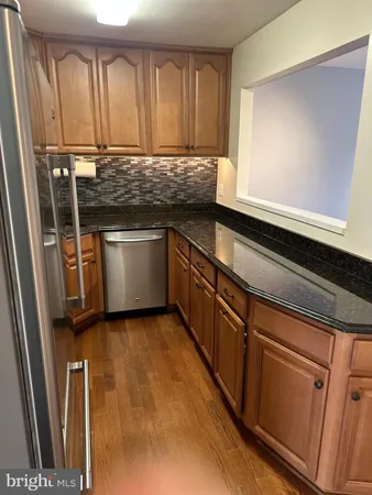 a kitchen with a refrigerator and a sink