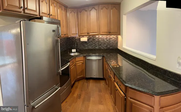 a kitchen with a refrigerator and a stove