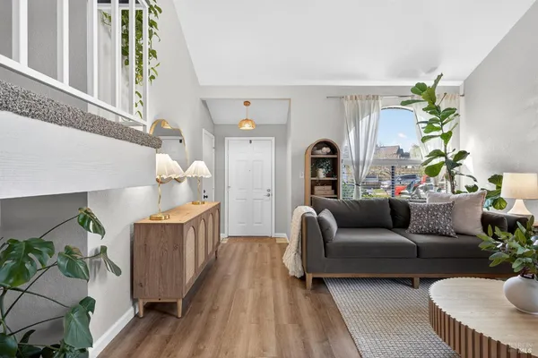 a living room with furniture and a potted plant