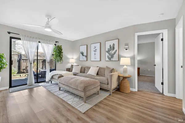 a bedroom with a large bed and a wooden floor