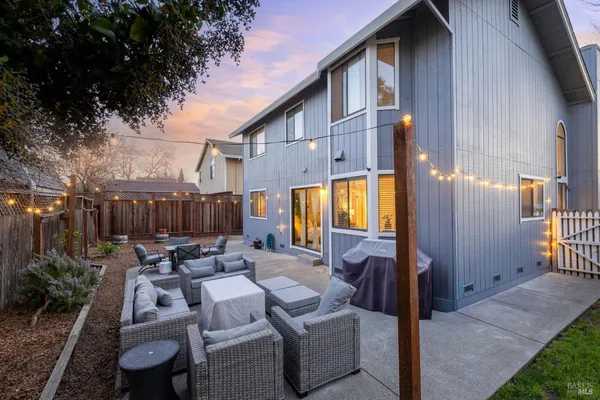 a view of backyard of house with seating space