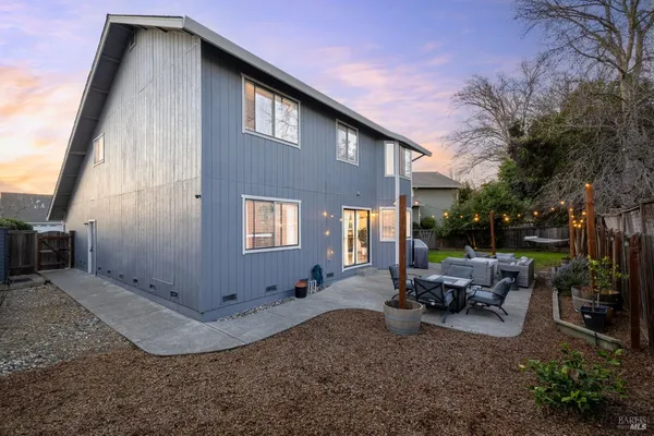 a backyard of a house with yard and outdoor seating