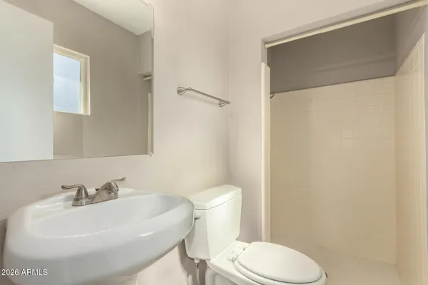 a white toilet sitting next to a bathroom sink