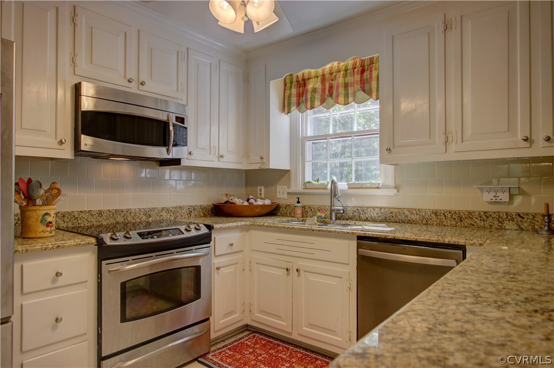 13711 Elmstead Road Midlothian, VA 23113 - Photo 15 of 47 a kitchen with granite countertop white cabinets appliances and a sink