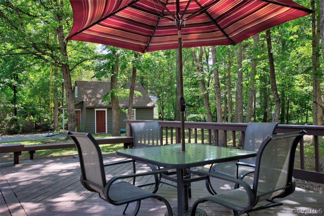 13711 Elmstead Road Midlothian, VA 23113 - Photo 28 of 47 a view of a patio with table and chairs under an umbrella