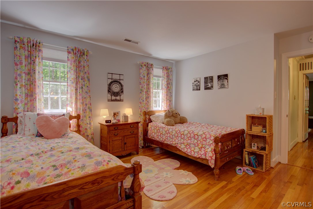 13711 Elmstead Road Midlothian, VA 23113 - Photo 34 of 47 a bedroom with a bed and wooden floor