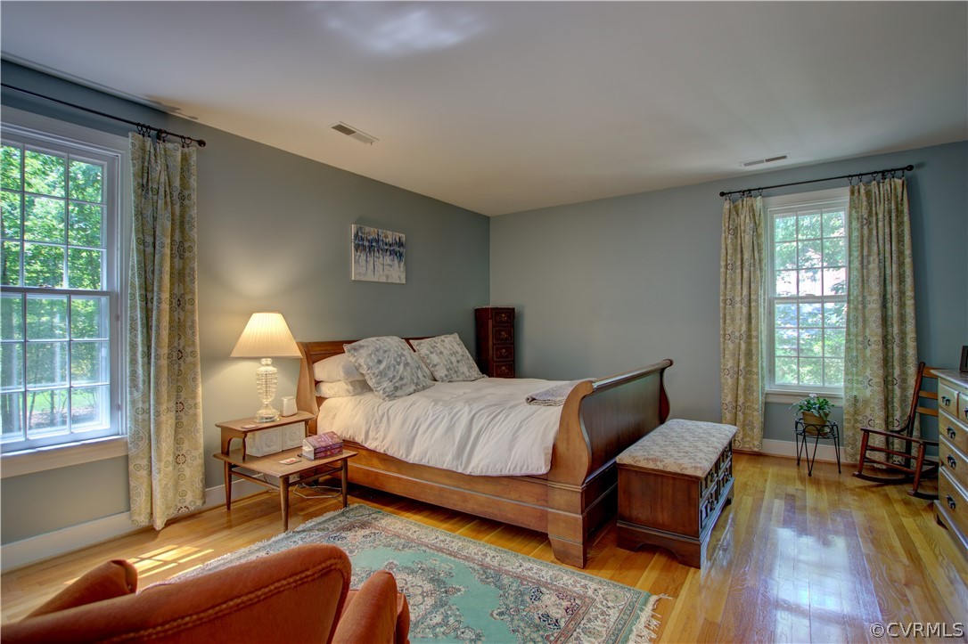 13711 Elmstead Road Midlothian, VA 23113 - Photo 36 of 47 a bedroom with a bed and wooden floor