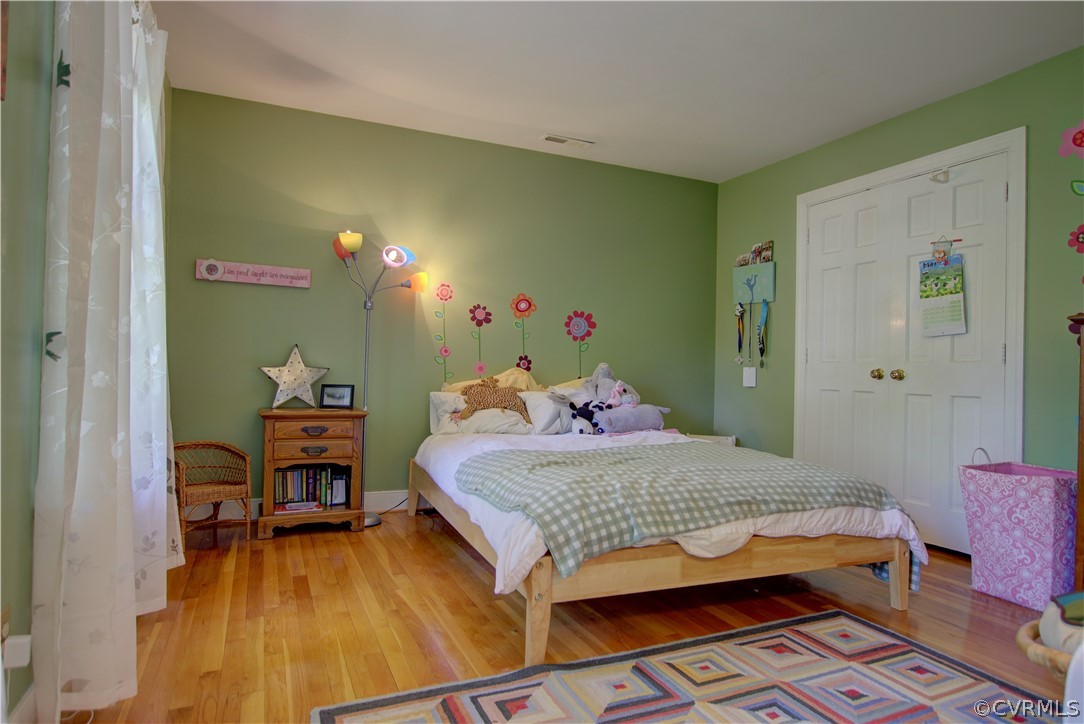 13711 Elmstead Road Midlothian, VA 23113 - Photo 40 of 47 a bedroom with a bed and a dresser in it