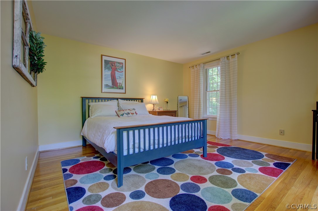13711 Elmstead Road Midlothian, VA 23113 - Photo 42 of 47 a bedroom with a bed and wooden floor