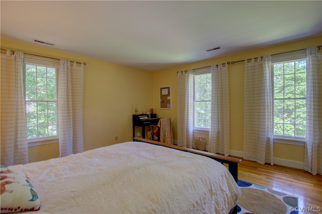 13711 Elmstead Road Midlothian, VA 23113 - Photo 44 of 47 a bedroom with a bed and wooden floor