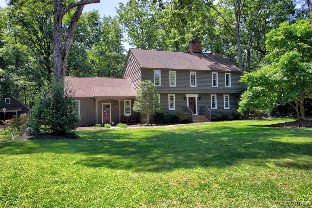 13711 Elmstead Road Midlothian, VA 23113 - Photo 46 of 47 a front view of a house with a yard table and trees