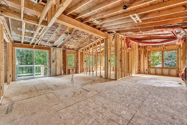 a view of a door with wooden floor and a shower