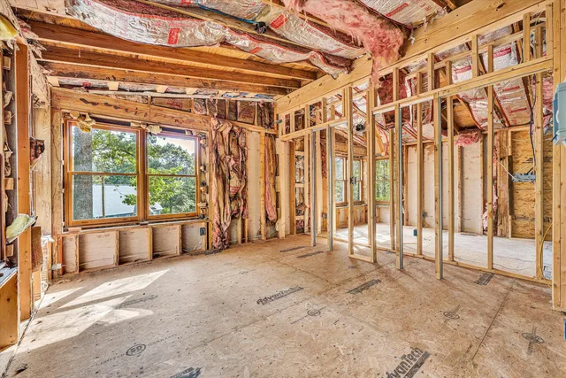 a kitchen with a refrigerator a stove top oven a sink dishwasher and dining table with wooden floor