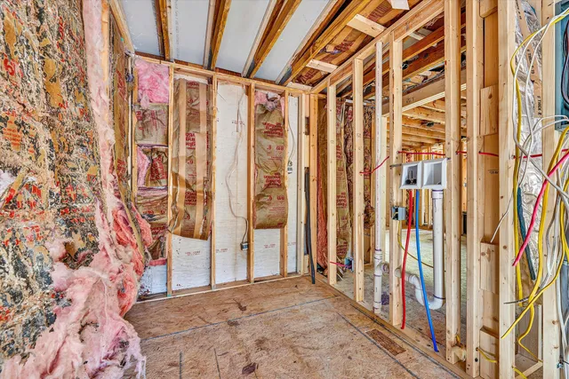 a bedroom with a bed and a large mirror on the dresser