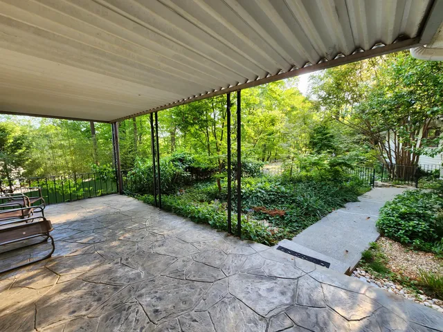 a bedroom with a bed and painting on the wall
