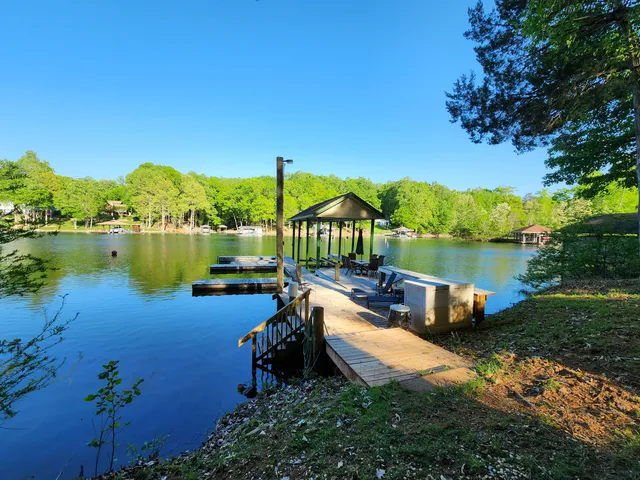 a view of a lake with large trees