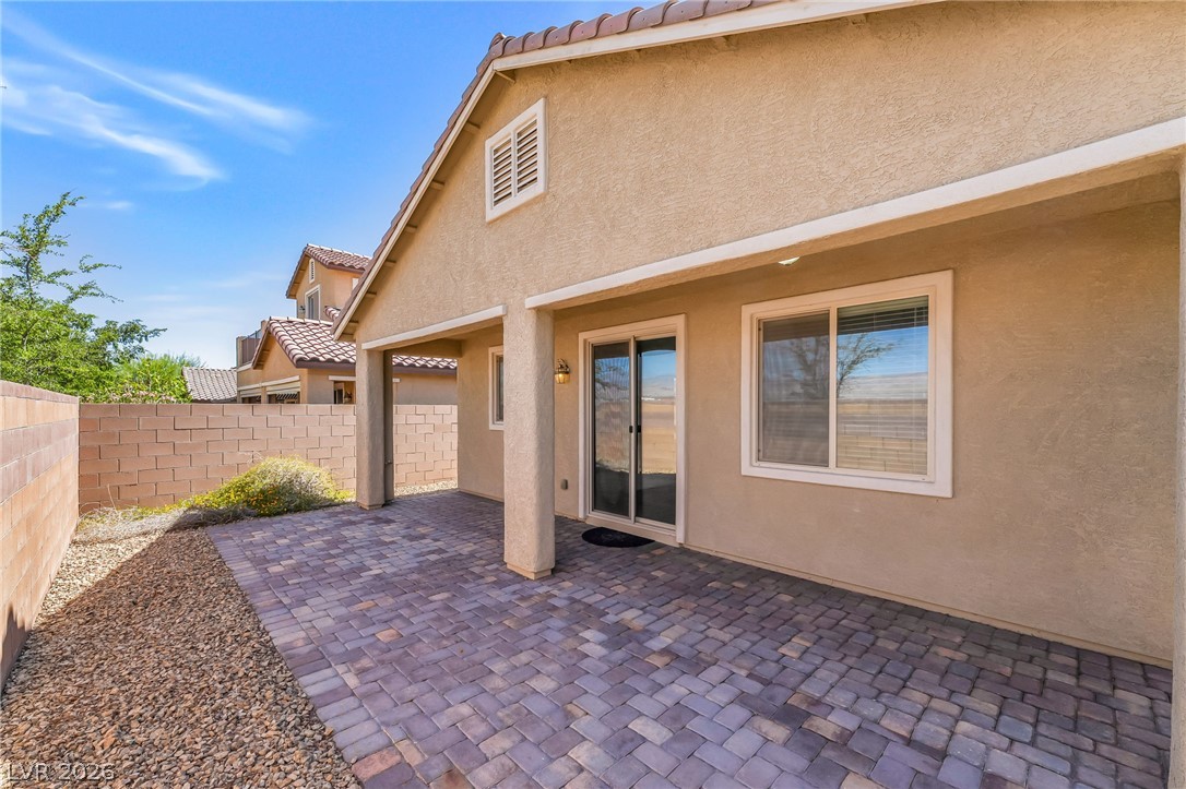 6245 Andover Wood Road Las Vegas, NV 89113 - Photo 32 of 37 A spacious brick paver patio extends from the home, perfect for outdoor enjoyment.