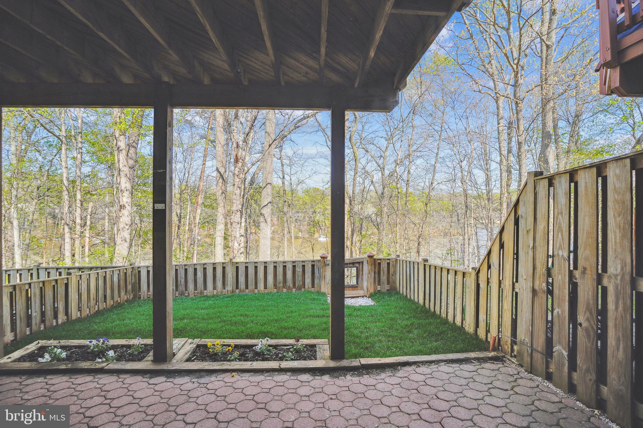 15761 Viewpoint Circle Dumfries, VA 22025 - Photo 26 of 46 a view of a house with a small yard and wooden fence