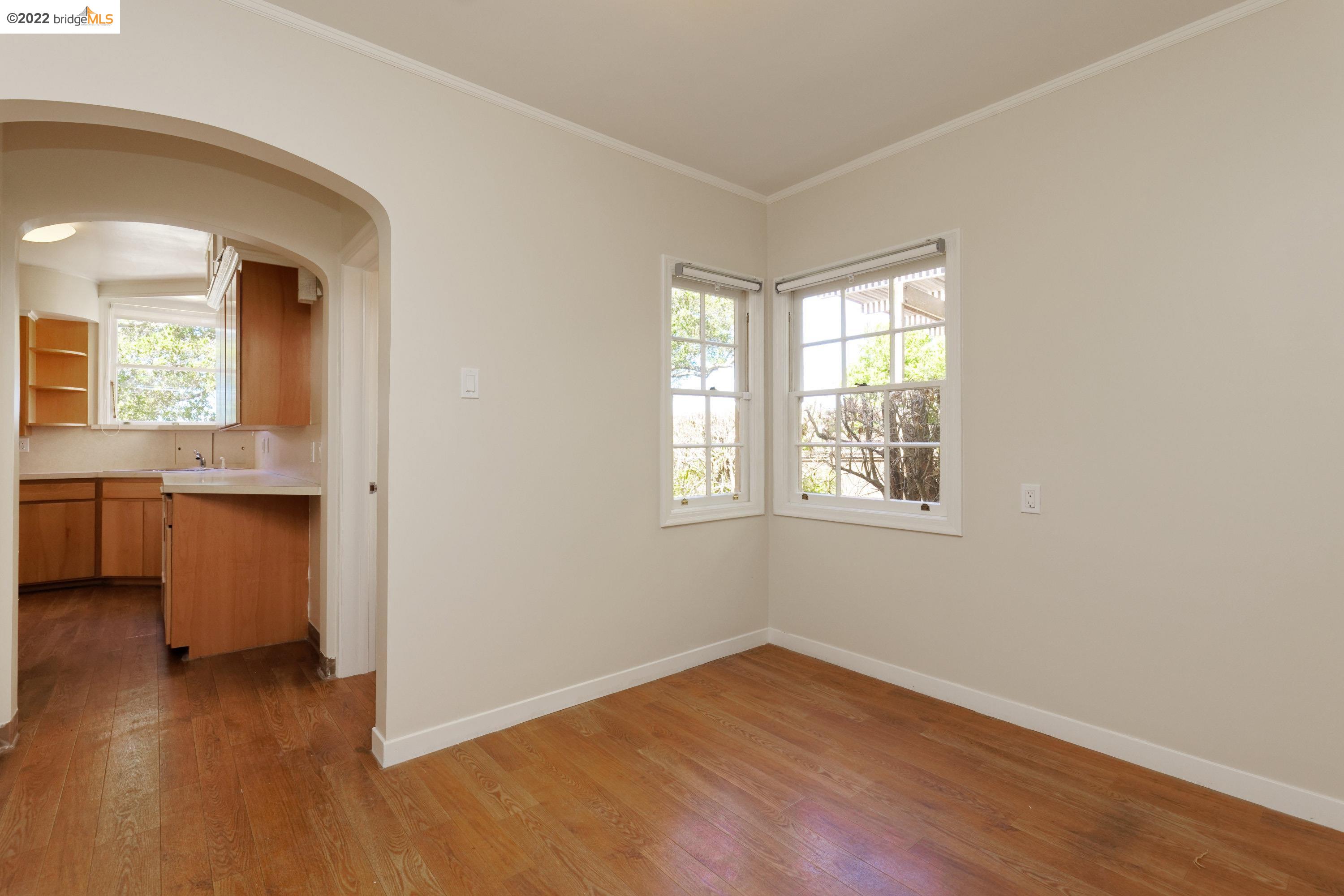 920 Spruce Street Berkeley, CA 94707 - Photo 15 of 36 an empty room with wooden floor and windows